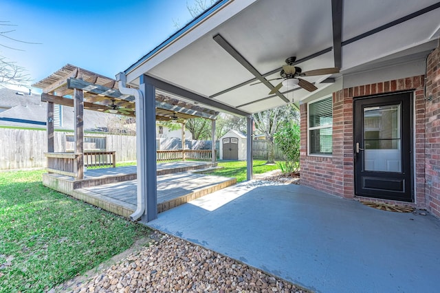 view of patio / terrace with ceiling fan and a storage unit