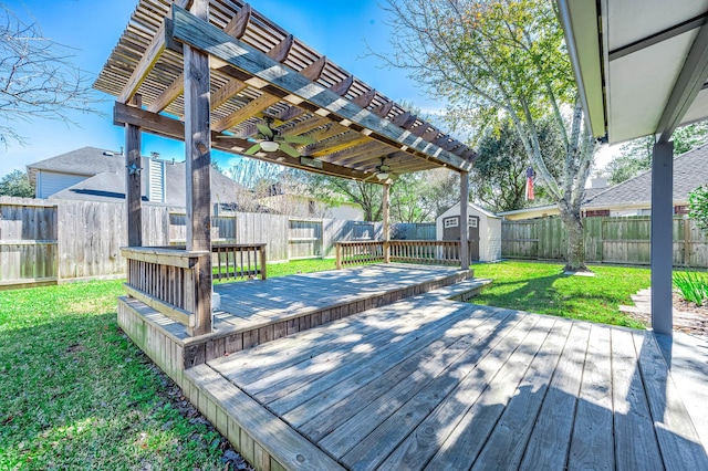 wooden terrace with a yard and a shed