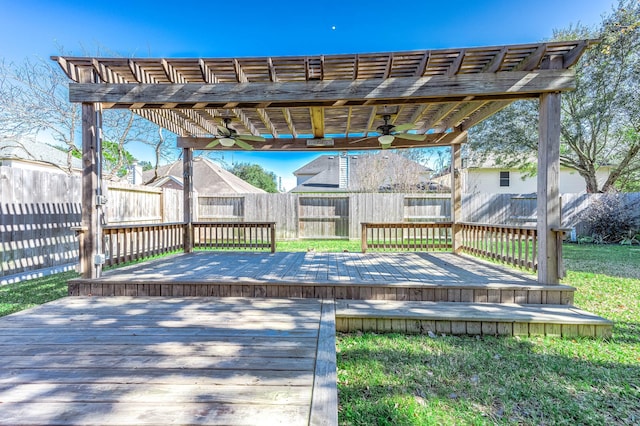 wooden deck with a pergola, ceiling fan, and a lawn