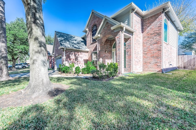 view of front facade with a front yard and a garage