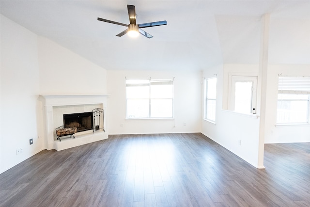 unfurnished living room featuring dark hardwood / wood-style floors, ceiling fan, a fireplace, and vaulted ceiling