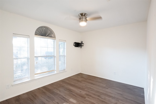 empty room featuring ceiling fan and dark hardwood / wood-style floors