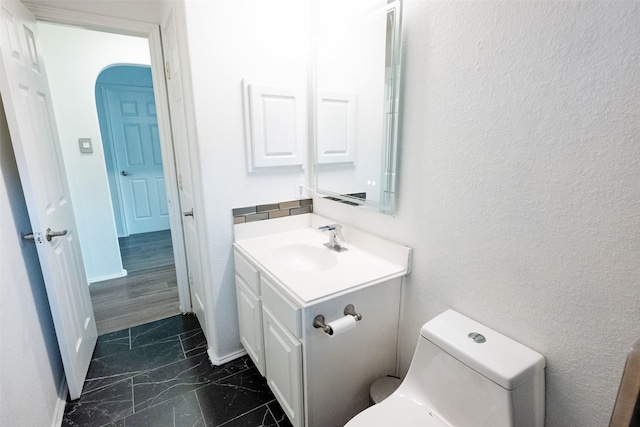 bathroom featuring vanity and toilet