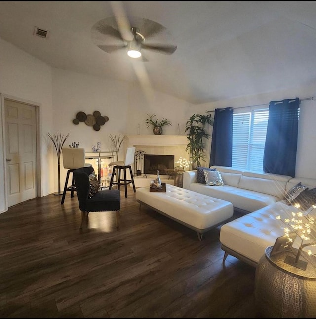 living room featuring ceiling fan and dark wood-type flooring