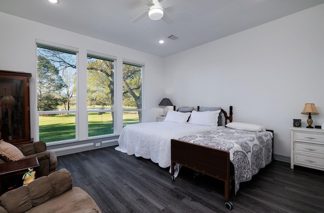 bedroom with ceiling fan and dark wood-type flooring