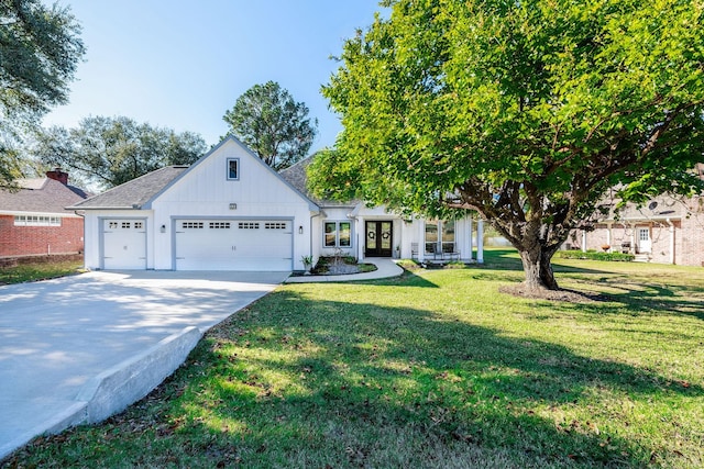 view of front of house featuring a front yard, french doors, and a garage