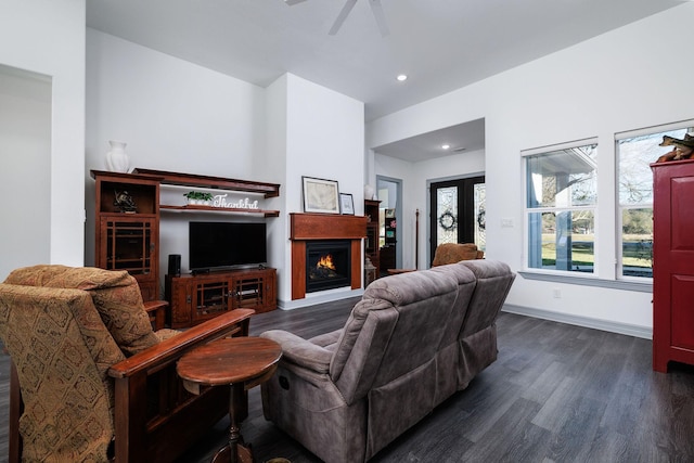 living room with dark hardwood / wood-style floors and ceiling fan