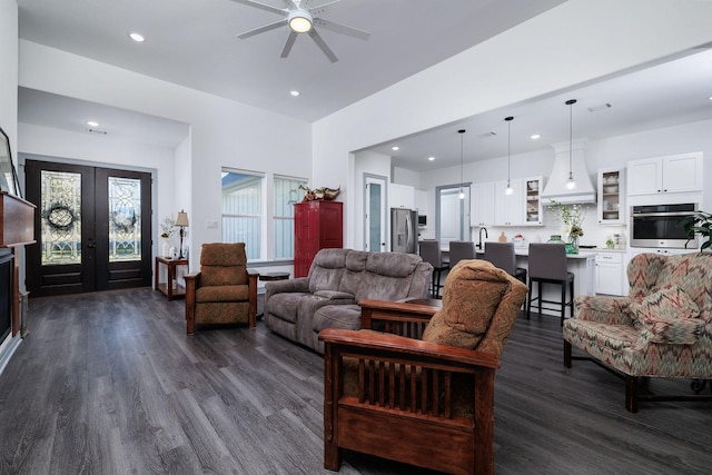 living room featuring ceiling fan, french doors, and dark wood-type flooring