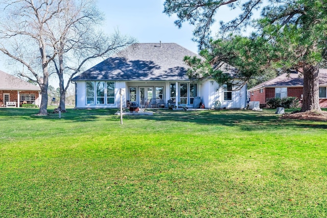 back of house featuring a yard