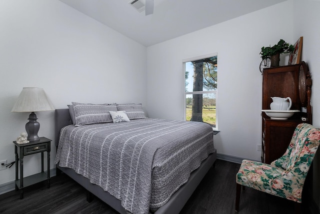 bedroom featuring ceiling fan and dark wood-type flooring