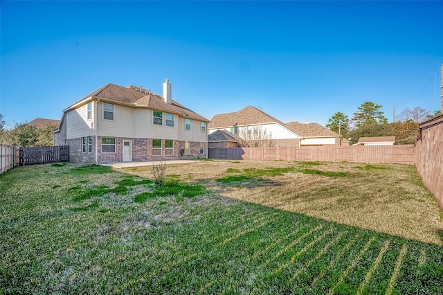 rear view of house featuring a yard