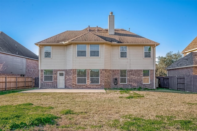 back of property featuring a patio area and a lawn