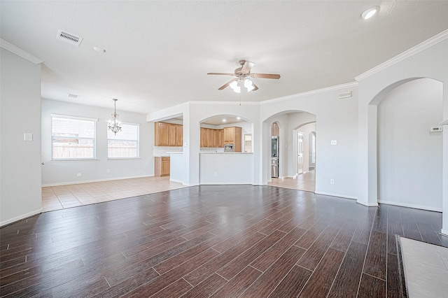 unfurnished living room featuring ceiling fan with notable chandelier, light hardwood / wood-style flooring, and ornamental molding