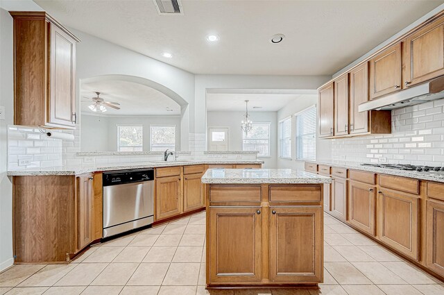 kitchen with decorative light fixtures, a center island, light tile patterned floors, kitchen peninsula, and stainless steel appliances