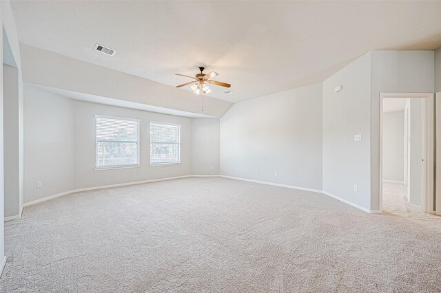 carpeted spare room with lofted ceiling and ceiling fan