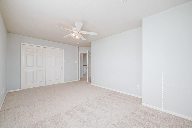 unfurnished bedroom with carpet floors, a closet, and ceiling fan