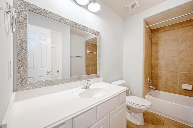 full bathroom with vanity, toilet, tiled shower / bath combo, and tile patterned flooring