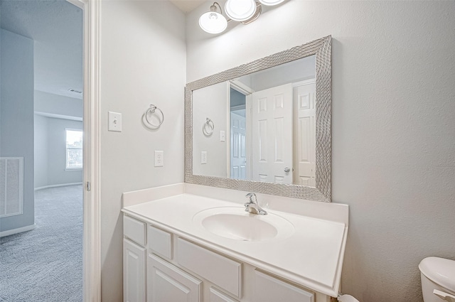 bathroom featuring vanity and toilet