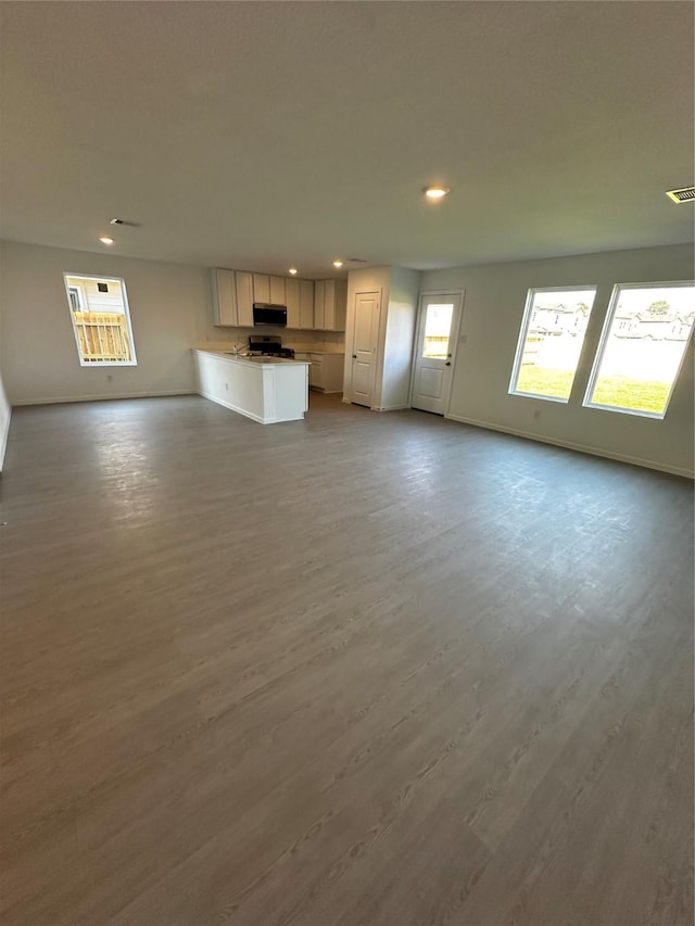 unfurnished living room with light hardwood / wood-style floors