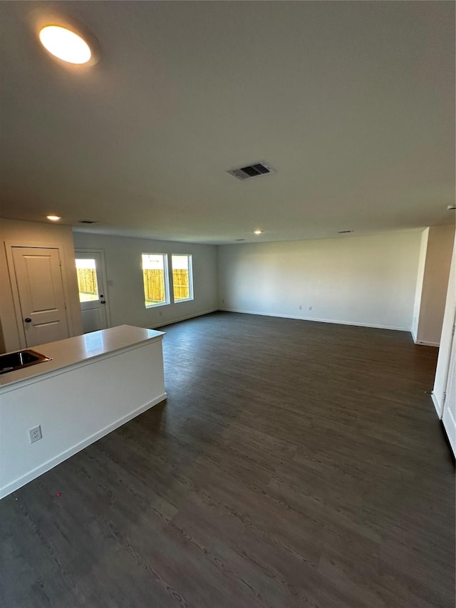 unfurnished living room with dark hardwood / wood-style floors