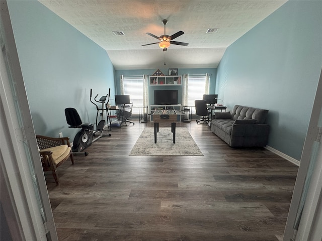 living room with dark hardwood / wood-style flooring, a textured ceiling, vaulted ceiling, and ceiling fan