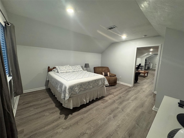 bedroom featuring hardwood / wood-style floors and lofted ceiling