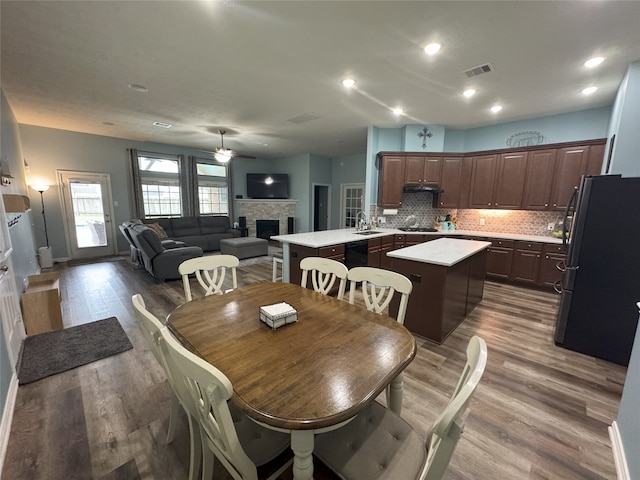 dining room featuring hardwood / wood-style flooring, ceiling fan, and sink