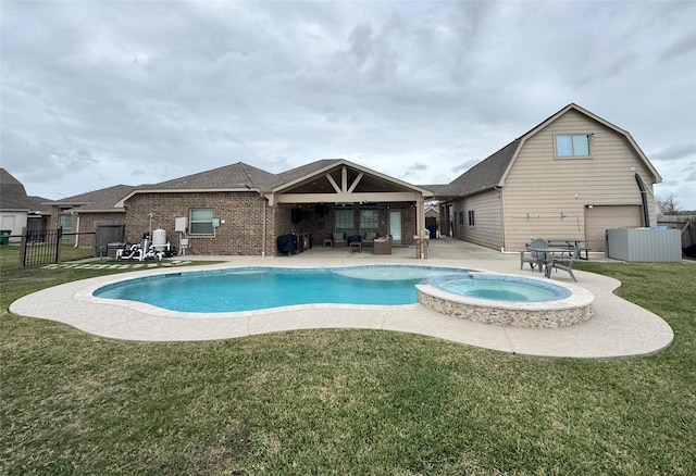 view of pool featuring ceiling fan, a patio area, a yard, and an in ground hot tub