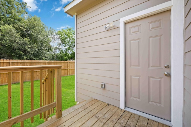 wooden terrace featuring a lawn