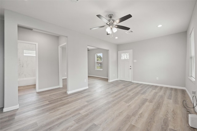 unfurnished living room featuring ceiling fan and light wood-type flooring