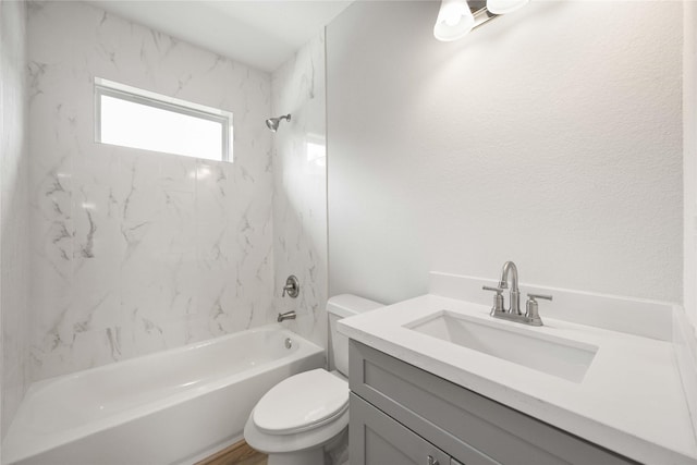 full bathroom featuring vanity, toilet, and tiled shower / bath