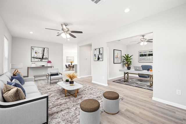 living room with recessed lighting, wood finished floors, and baseboards