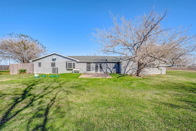 back of house featuring a lawn, central air condition unit, and a patio