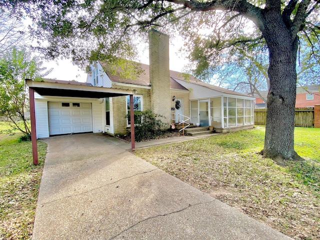 ranch-style house with a front yard and a carport