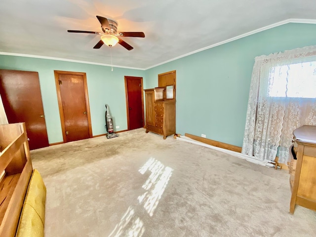 carpeted bedroom with two closets, vaulted ceiling, ceiling fan, and crown molding