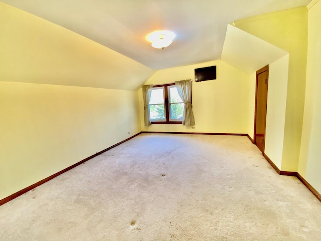 bonus room featuring light carpet and lofted ceiling