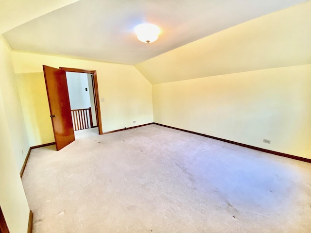 additional living space featuring light carpet and lofted ceiling