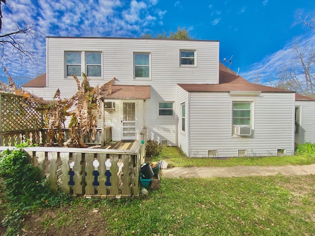 rear view of property featuring a yard, cooling unit, and a wooden deck