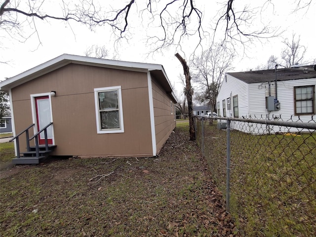 view of side of home featuring a yard