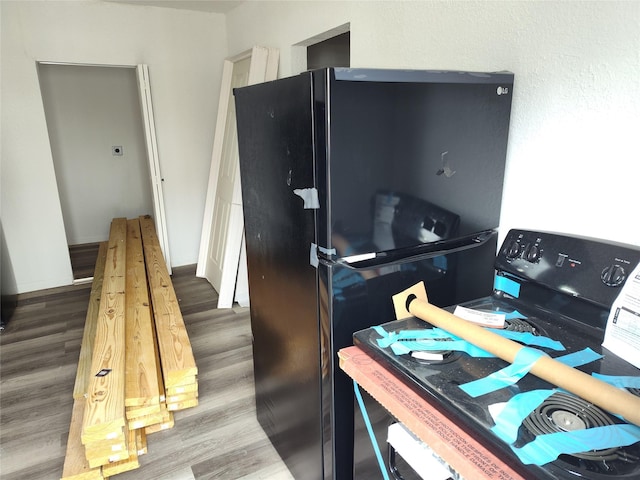 interior space featuring hardwood / wood-style flooring and washer / dryer