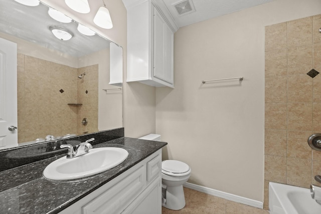 full bathroom featuring toilet, vanity, tiled shower / bath combo, and tile patterned floors