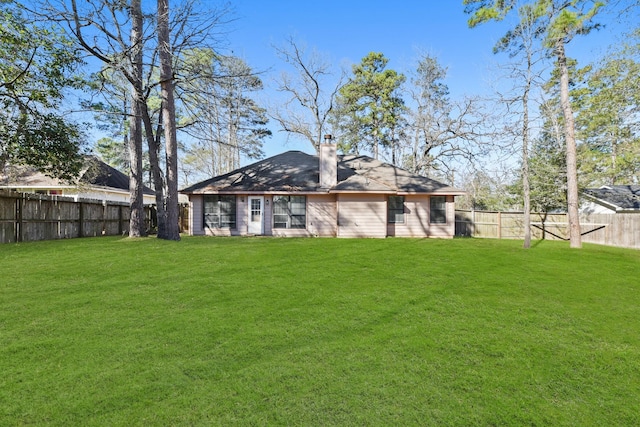 rear view of property featuring a yard