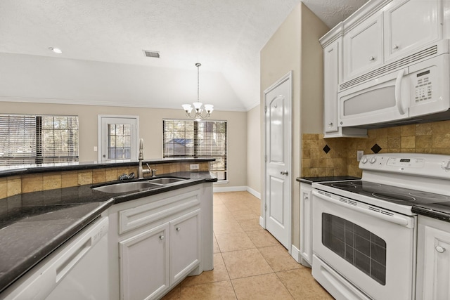 kitchen featuring white cabinets, lofted ceiling, white appliances, and sink