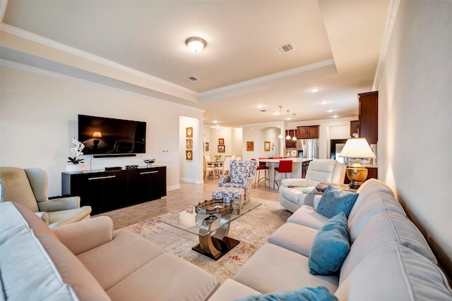 tiled living room featuring a raised ceiling and crown molding