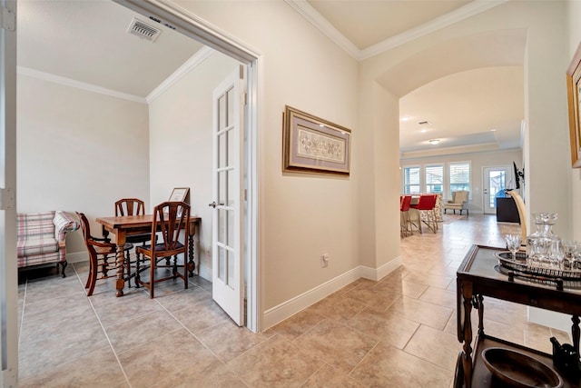 hall with crown molding, french doors, and light tile patterned floors