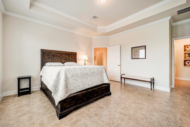 bedroom with a raised ceiling and crown molding