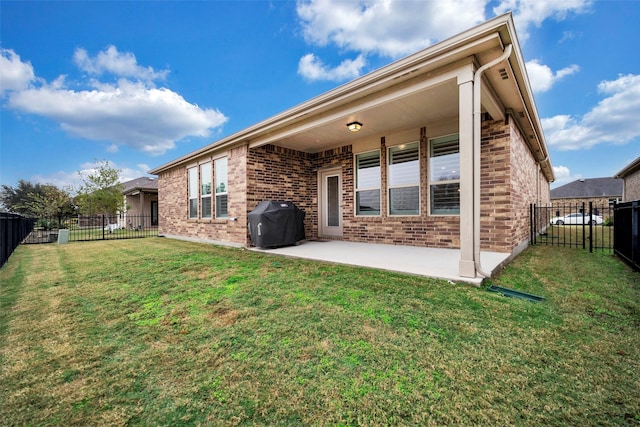 rear view of property with a lawn and a patio area