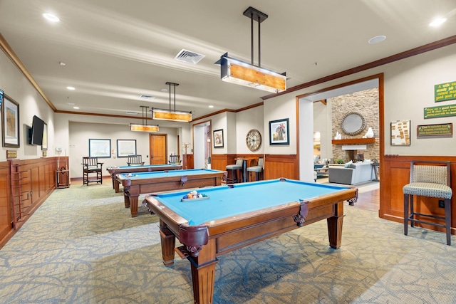 rec room with wood walls, light colored carpet, ornamental molding, and billiards