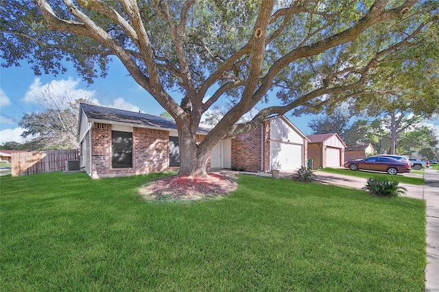 ranch-style house featuring a garage, a front yard, and central AC