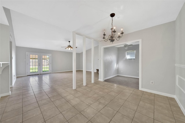 tiled empty room featuring french doors and ceiling fan with notable chandelier